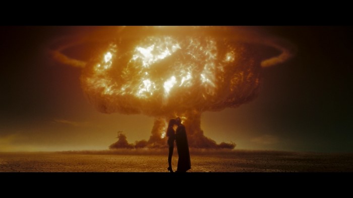 Couple kissing in front of nuclear explosion