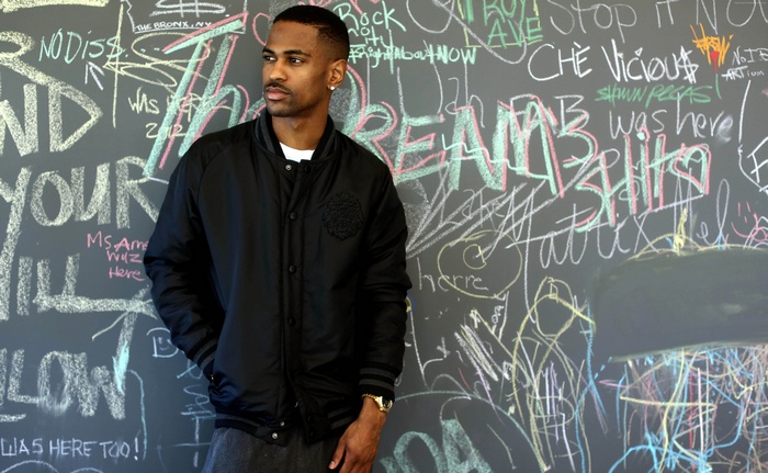 Big Sean in front of a chalk-covered wall