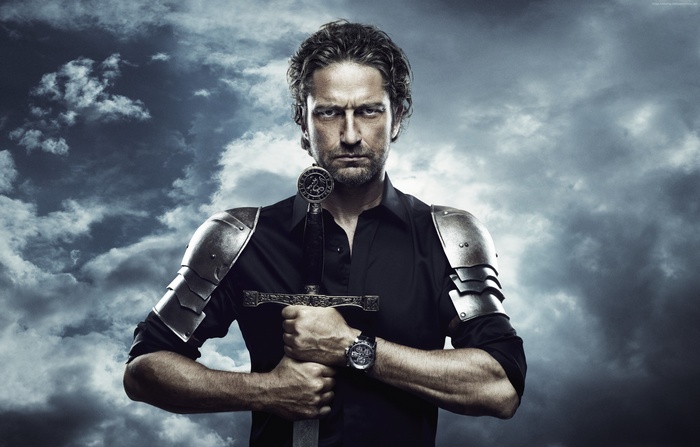 Gerard Butler holding a sword with armor