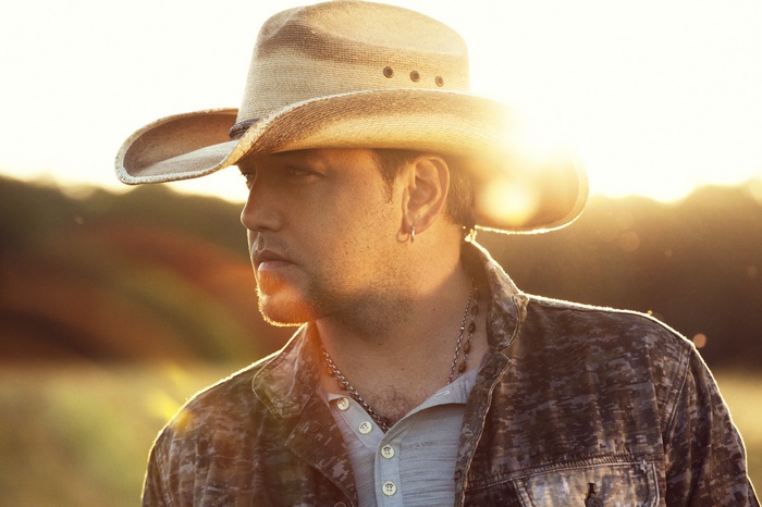 Jason Aldean wearing a cowboy hat and camouflage jacket