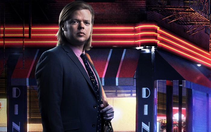 Man in Suit Standing in Front of Neon Lights