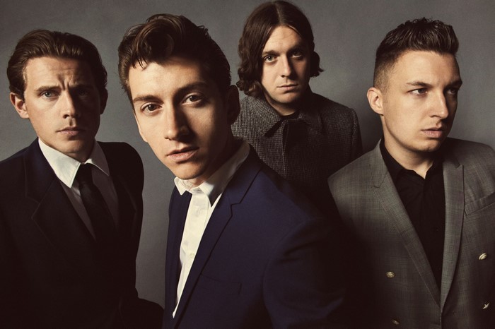 Arctic Monkeys band members posing for a photo