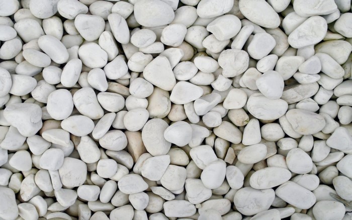 A pile of smooth white pebbles and stones