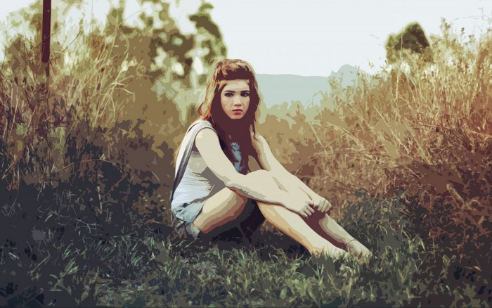 Young woman sitting in tall grass