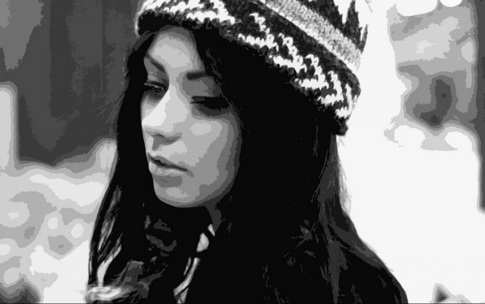 Monochrome portrait of Danielle Mansutti wearing a hat