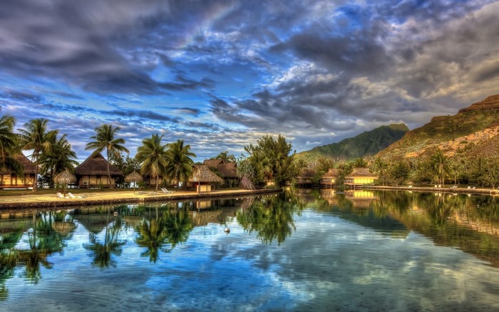 Tropical resort with overwater bungalows and mountains