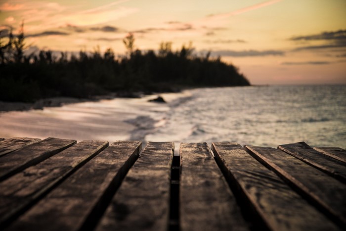 Wooden pier overlooking the ocean at sunset