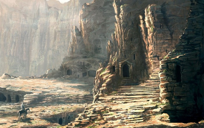 Ancient rock formations with carved dwellings and a lone rider