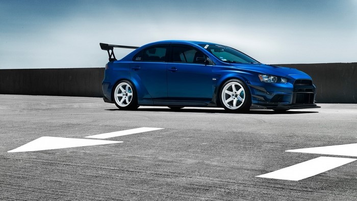 Blue Mitsubishi Lancer Evolution with White Wheels