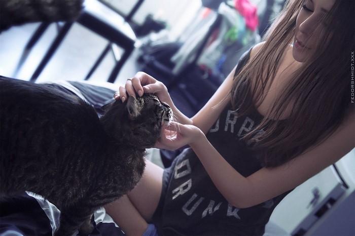 Woman petting a black cat