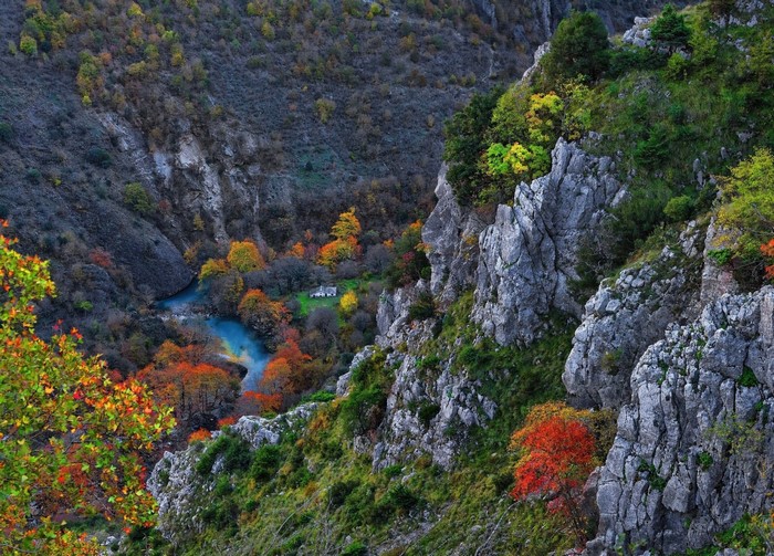 Autumn River Gorge with Rocky Cliffs and Colorful Trees