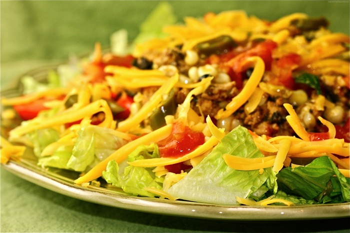 Taco salad with lettuce, tomatoes, cheese, and meat
