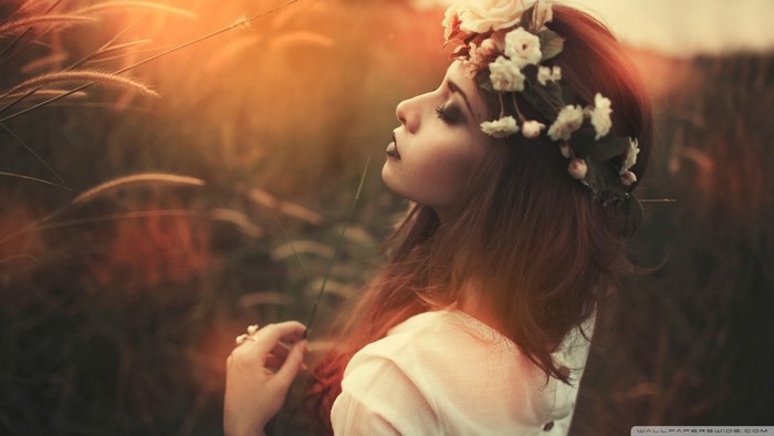 Woman with flower crown in a field