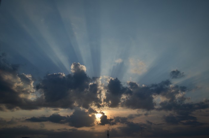 Sunbeams shining through clouds at sunset