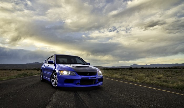Blue Mitsubishi Lancer Evolution on a Road