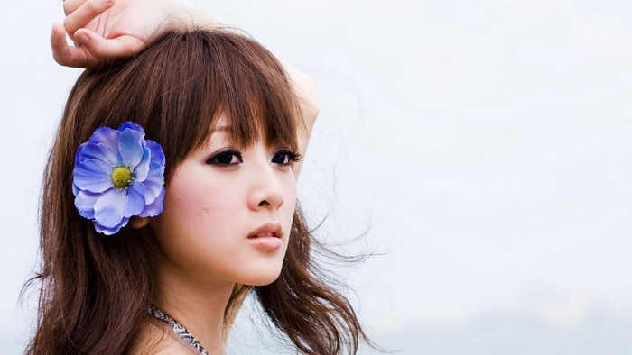 Asian woman with flower in hair