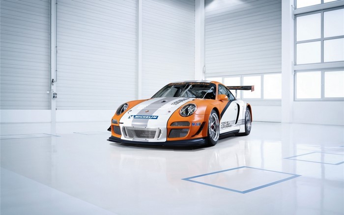 Porsche 911 GT3 race car in a clean garage