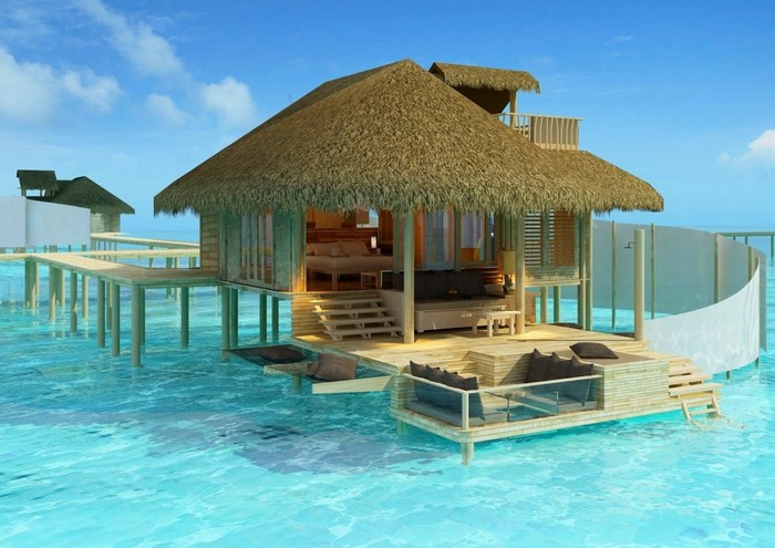 Overwater bungalow resort in turquoise ocean