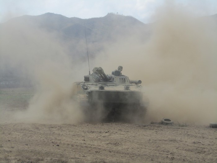 BMP-3 infantry fighting vehicle in dust cloud