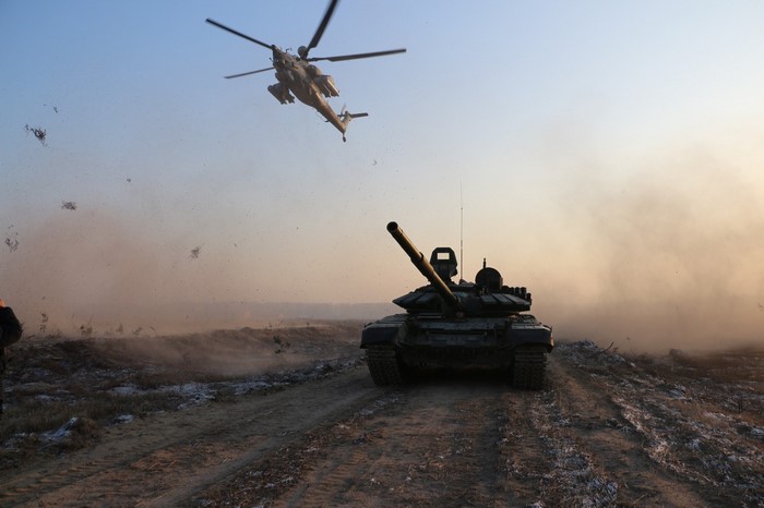Mil Mi-28 helicopter and T-90 tank in military exercise