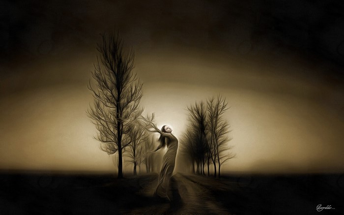 Woman dancing among bare trees in misty light
