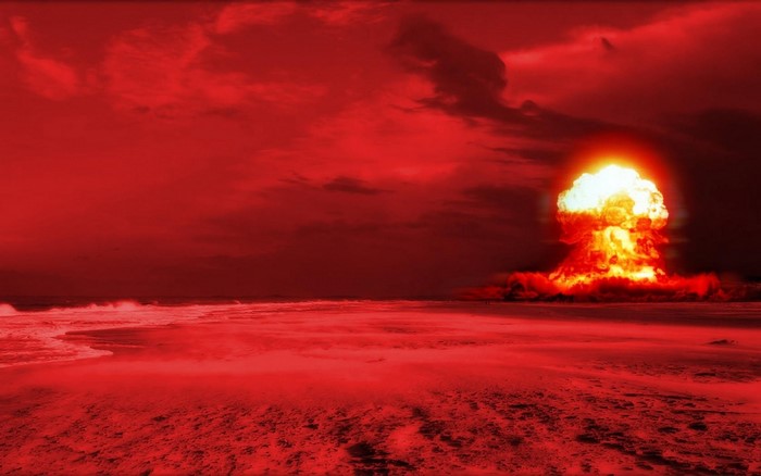 Nuclear explosion over a beach at sunset