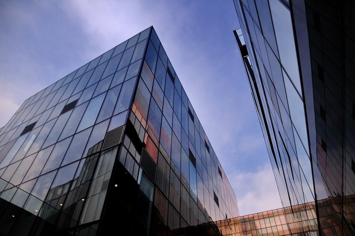 Modern glass buildings against a blue sky