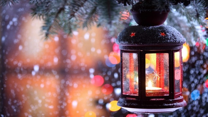 Christmas lantern with candle and snow
