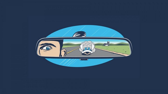 Man looking in rearview mirror at Mario Kart Blue Shell