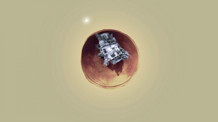 Mars rover in a crater with sun