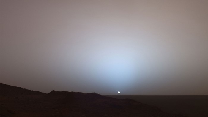 Mars sunset with blue glow over rocky terrain