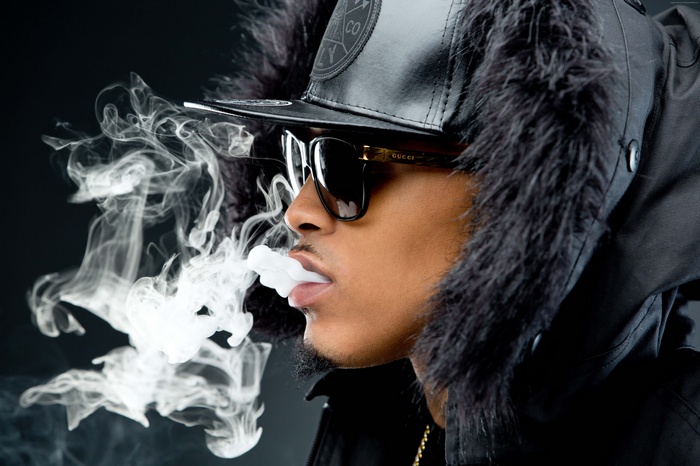 August Alsina exhaling smoke wearing Gucci sunglasses
