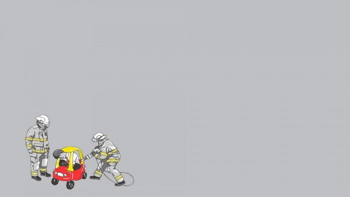 Firefighters rescuing a person from a toy car