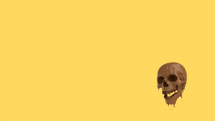 Chocolate skull melting on yellow background