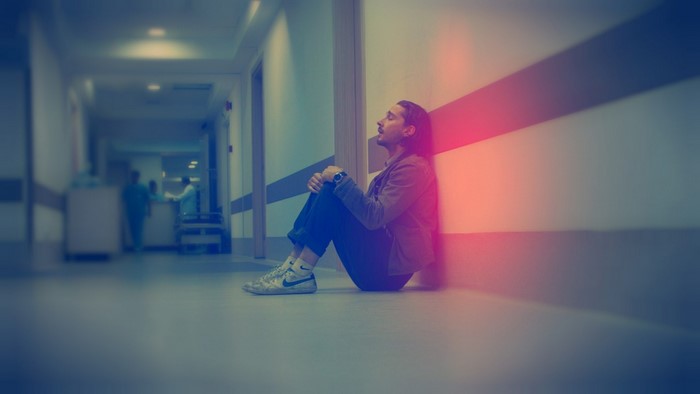 Man sitting in hospital hallway