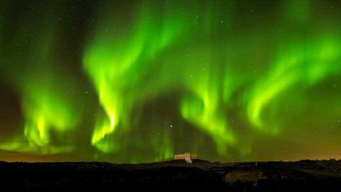 Aurora Borealis over a building and landscape