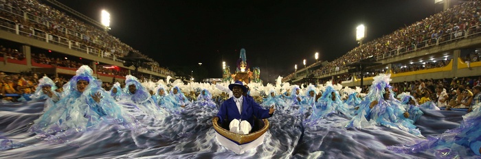 Rio Carnival parade with dancers and a man in a boat