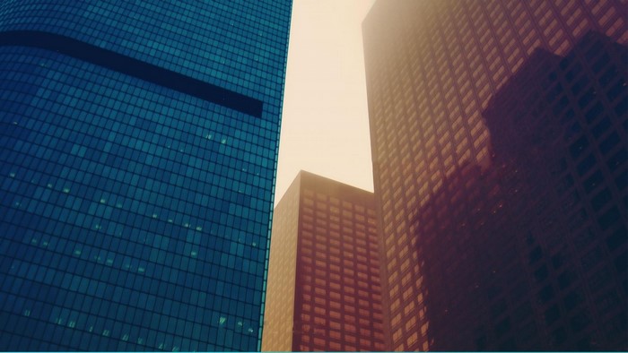Low angle view of modern skyscrapers with blue and brown facades
