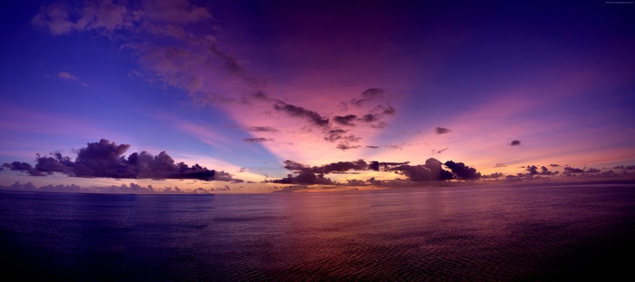 Purple sunset rays over the Pacific Ocean 4K