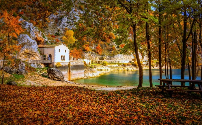 Autumn landscape with a house by a lake in Italy