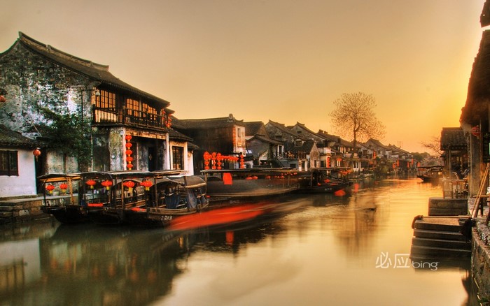 Boats on a canal in an old town at sunset