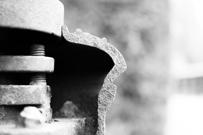 Close-up of rusted metal bolts and pipe fitting