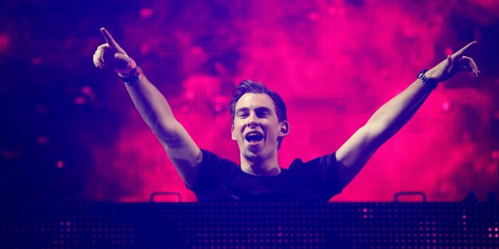 DJ Hardwell performing on stage with pink lights