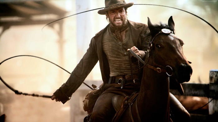 Hugh Jackman as a cowboy on a horse with a whip