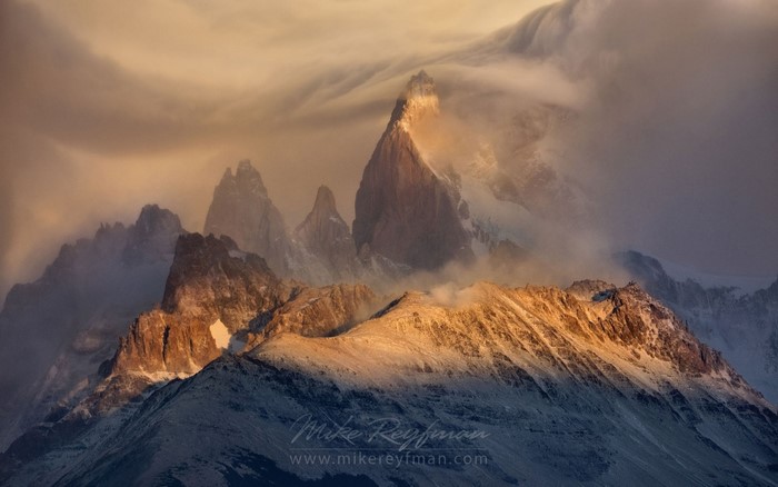 Mountain peaks at sunrise with clouds