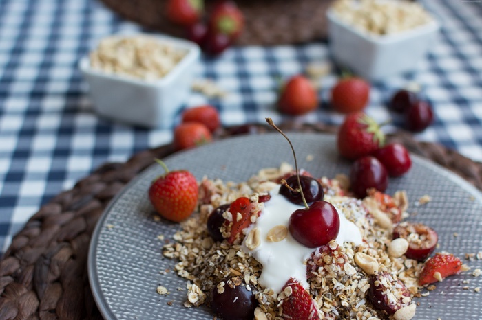 Granola with yogurt, strawberries, and cherries