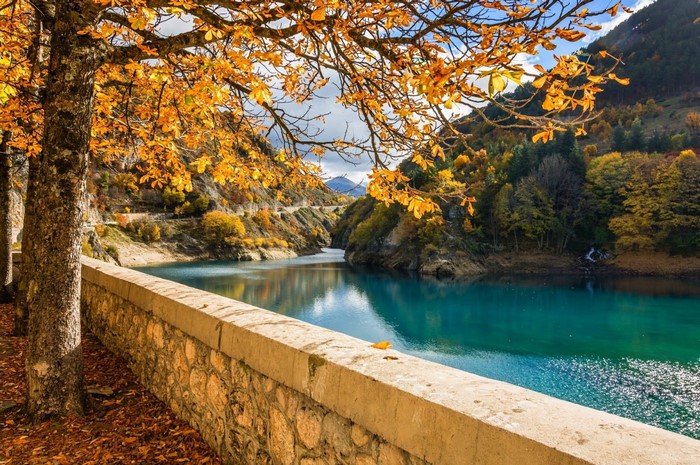 Autumn landscape with a turquoise lake and mountains