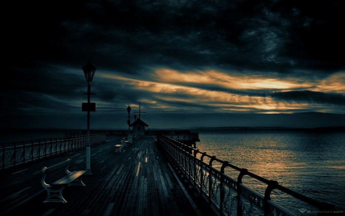 Pier at Dusk with Dramatic Clouds Over the Ocean