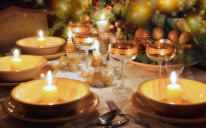 Christmas dinner table setting with candles and decorations