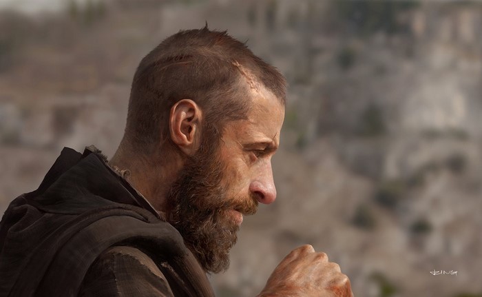 Man with beard and scars in profile